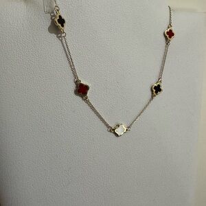 Elegant Gold Necklace with Red, Black, and White Accents